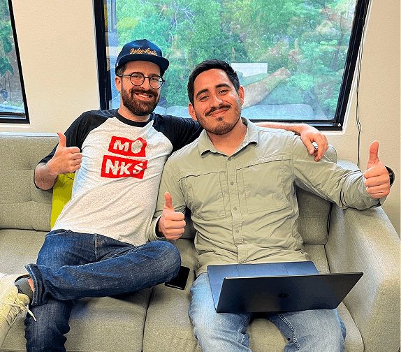 Two employees relaxing together in a collaborative workspace.