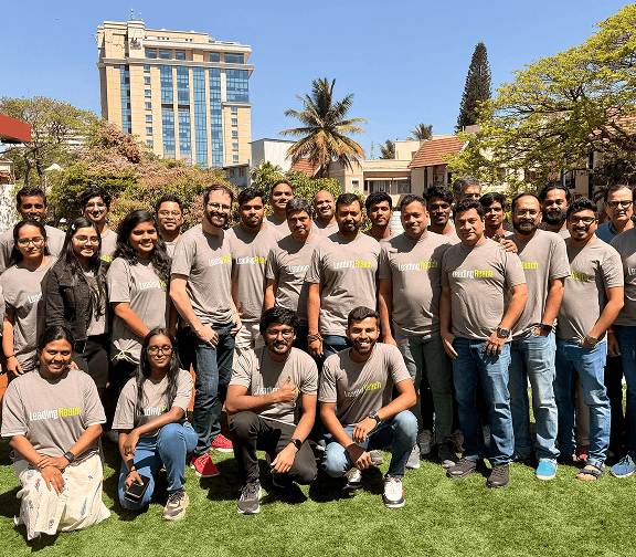 Team members posing outdoors during a company event.