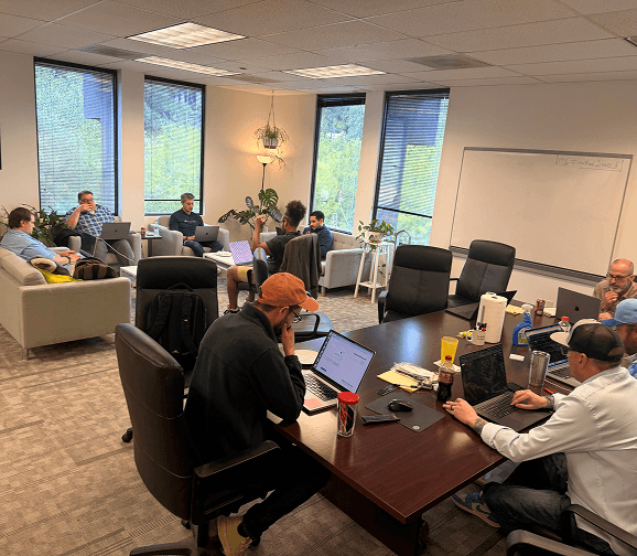 Team members collaborating during a meeting in a conference room.