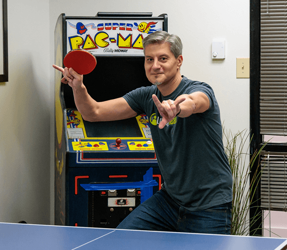 Employee playing an arcade game during a team event.