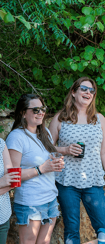Employees socializing outdoors during a company gathering.